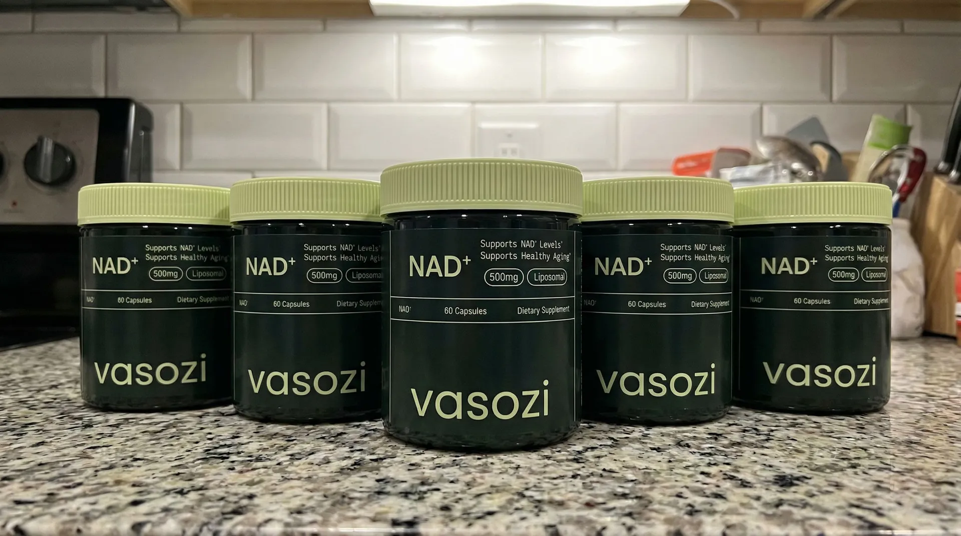 Five bottles of Vasozi NAD+ arranged on a kitchen counter